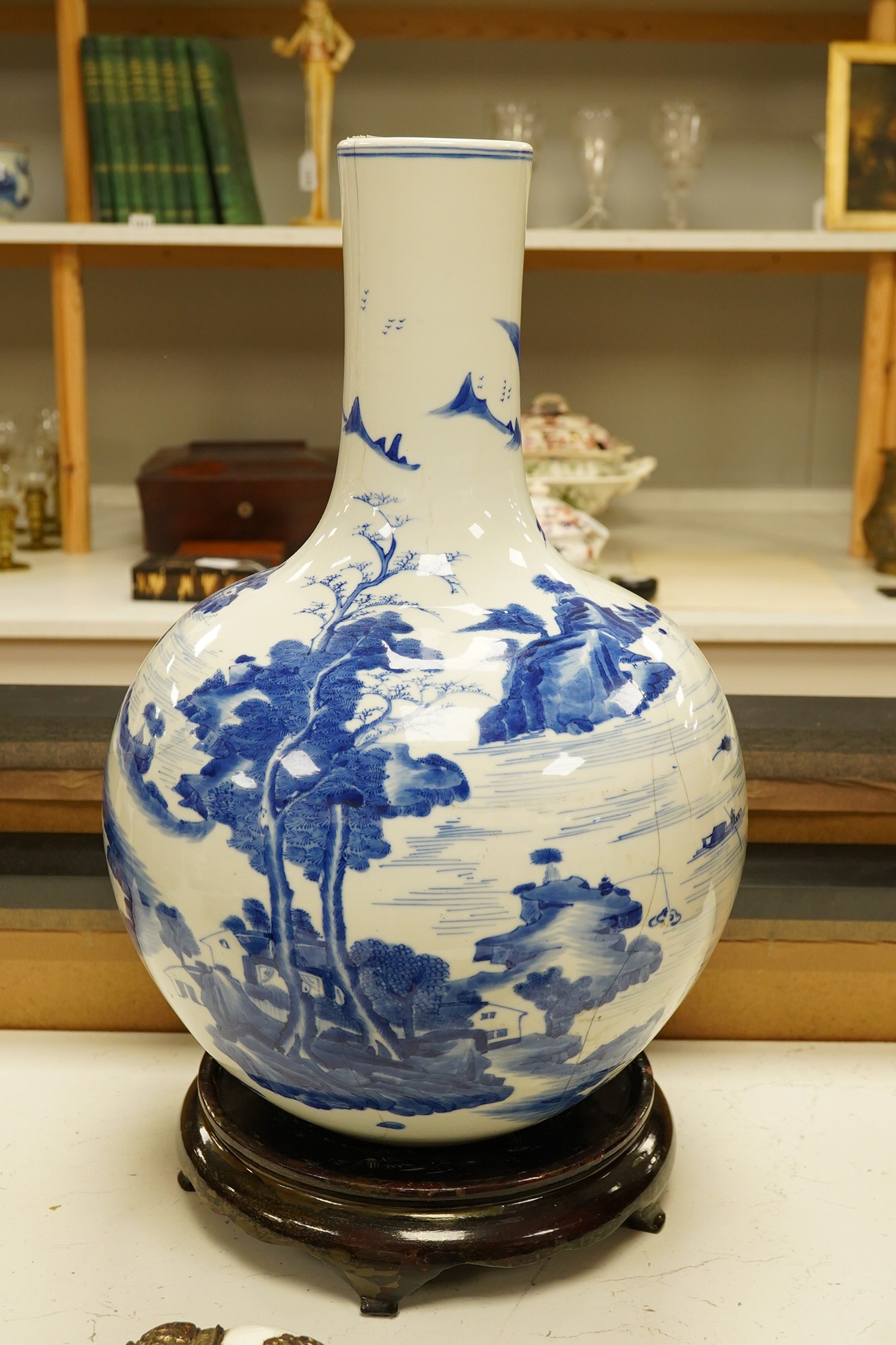 A Chinese blue and white bottle vase decorated with a landscape, 47cm high. Condition - poor